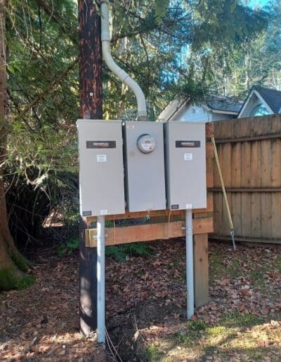 Generac electrical equipment and utility meter installed outdoors beside a home
