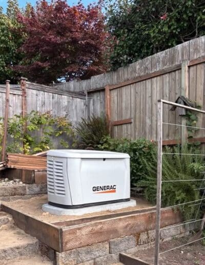 Generac home backup generator installed beside a residential garden