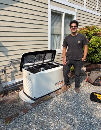 Technician beside an installed Generac home standby generator
